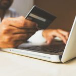 Ecommerce Advertising - person using laptop computer holding card