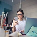 Print Business - woman in white shirt using smartphone