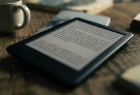 E-book - black tablet computer on brown wooden table